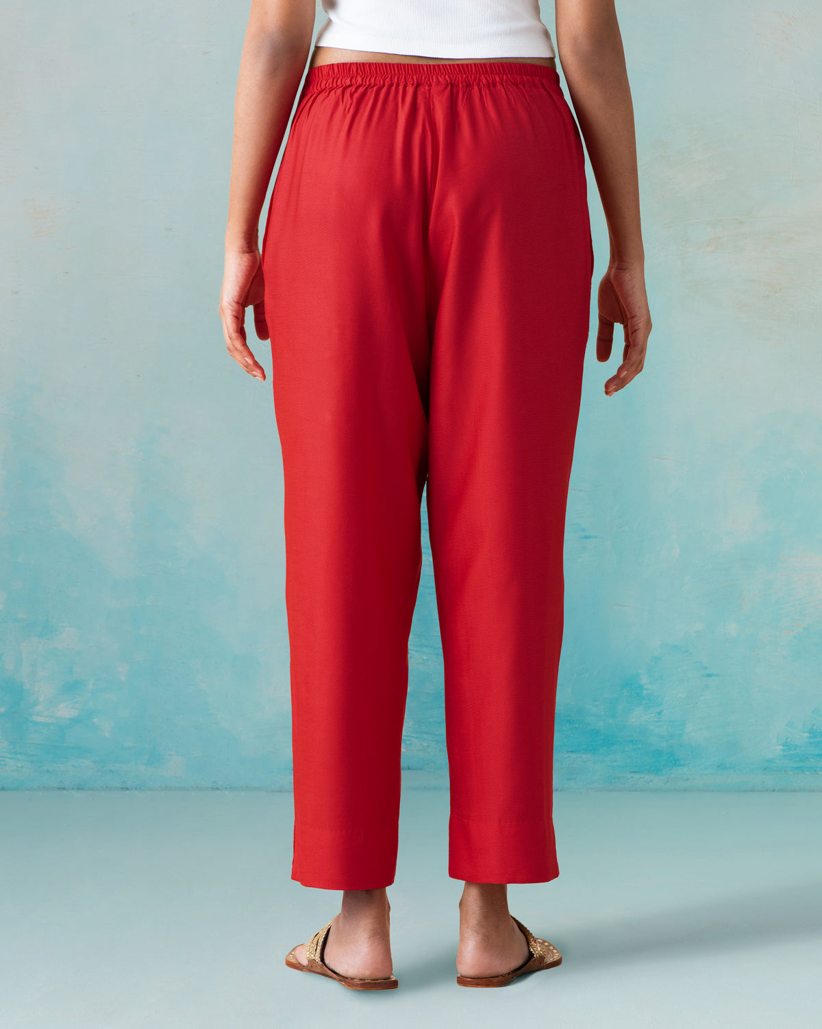 Back of red Novel pants with a gathered elastic waistband.