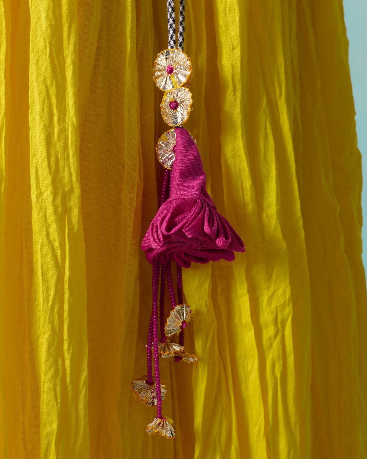 Person wearing a purple Berura skirt with gold motifs and a gold border.