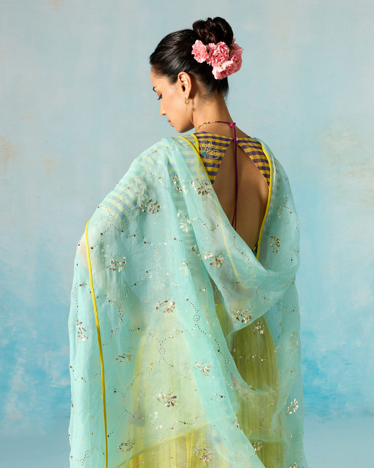 Back of a sea foam Adaa Dupatta with silver mukaish and a yellow border.