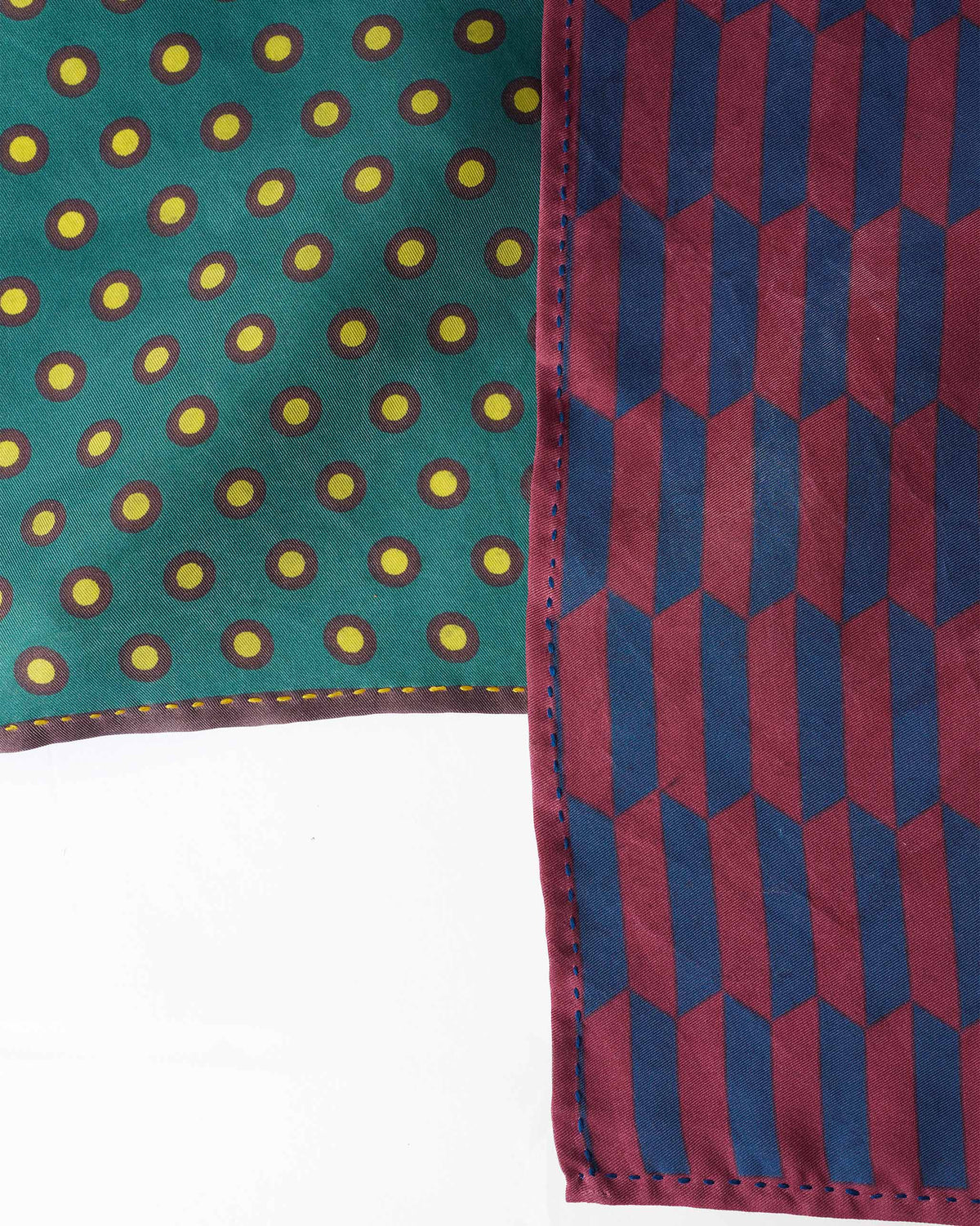 Close-up of Drongo silk pocket squares showing contrast hand-rolled hems.