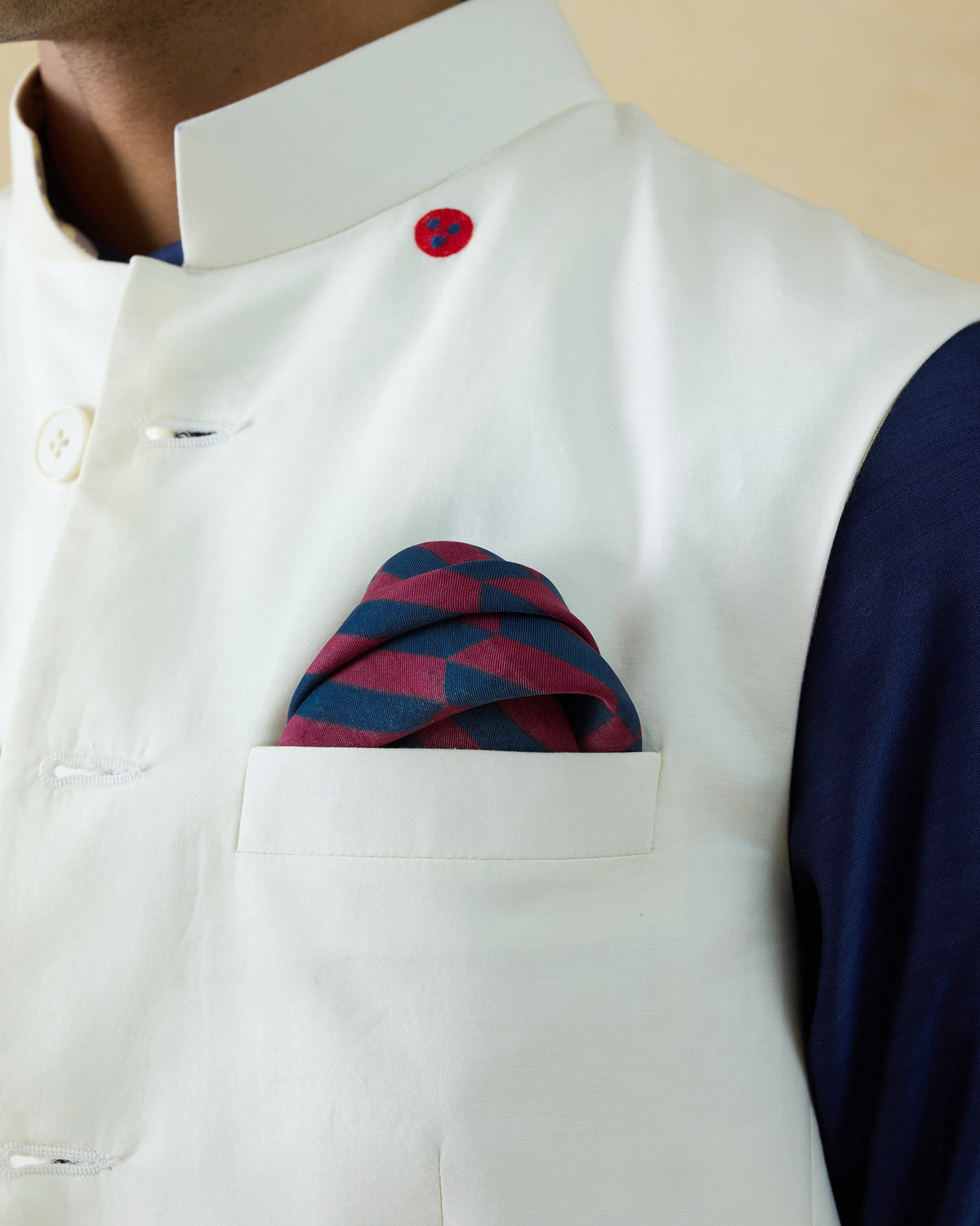 Drongo silk pocket square in a geometric print worn in a breast pocket.