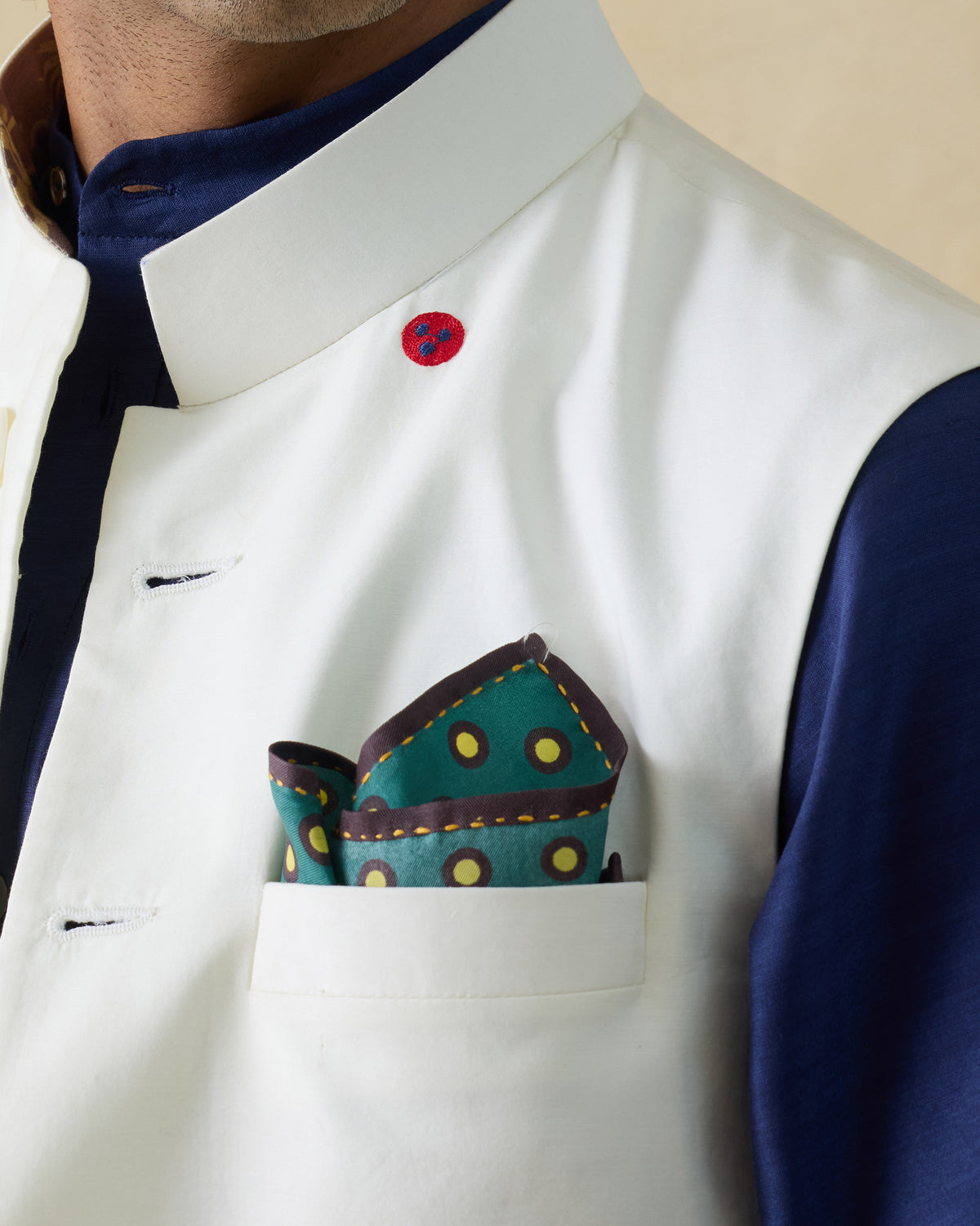 Drongo silk pocket square with yellow polka dots worn in a breast pocket.