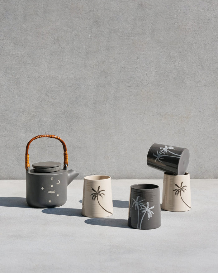 Taramandal tea set with a charcoal teapot and cream and charcoal palm kulhars.