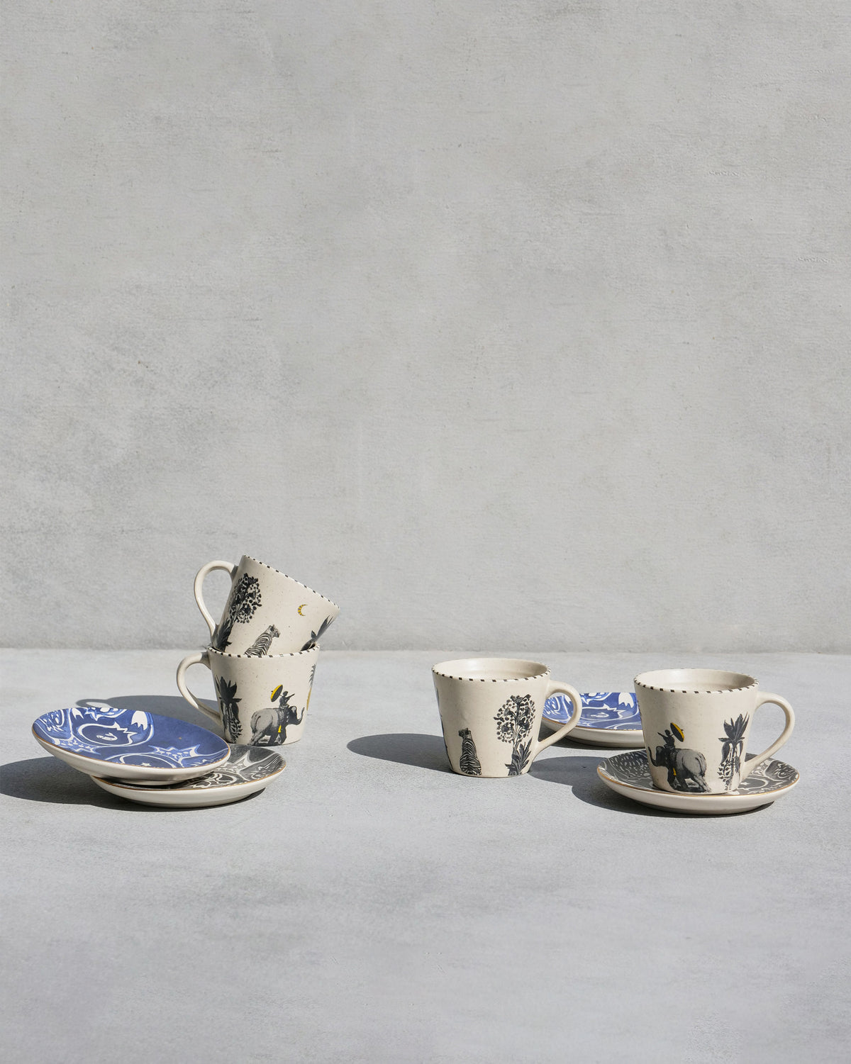 Teatime Set cups and saucers with black palm motifs.