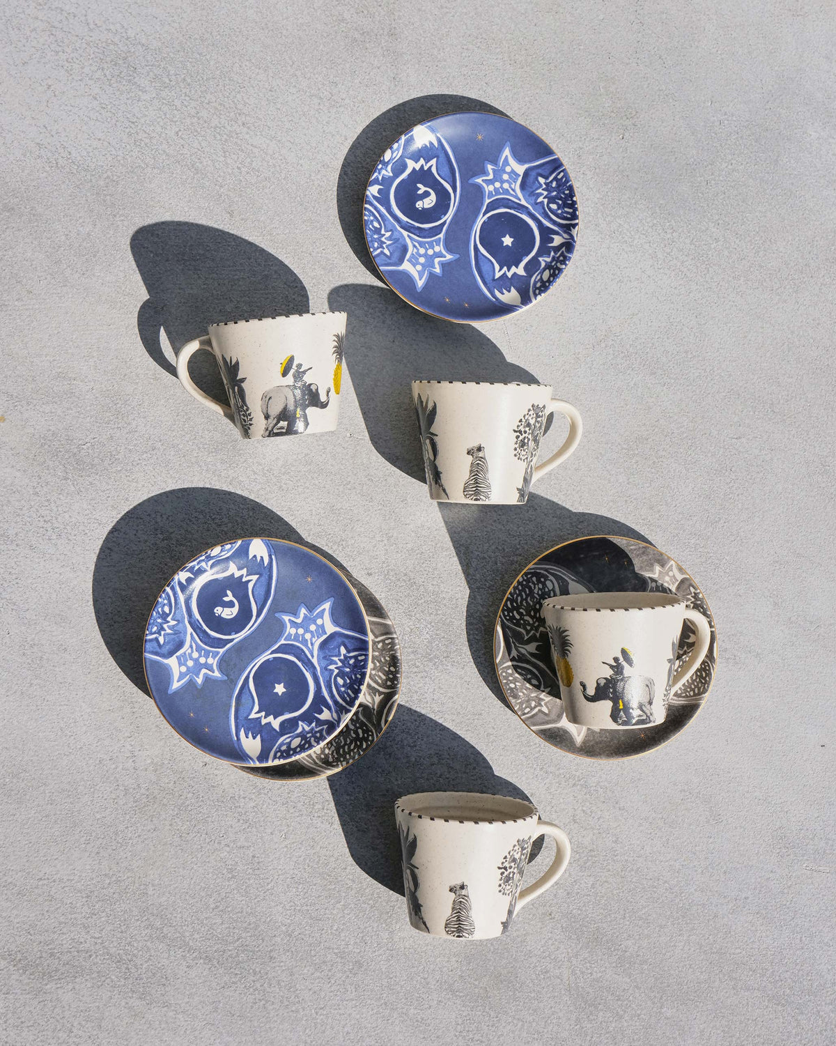 Teatime Set cups and saucers laid out from above, with blue patterned saucers.