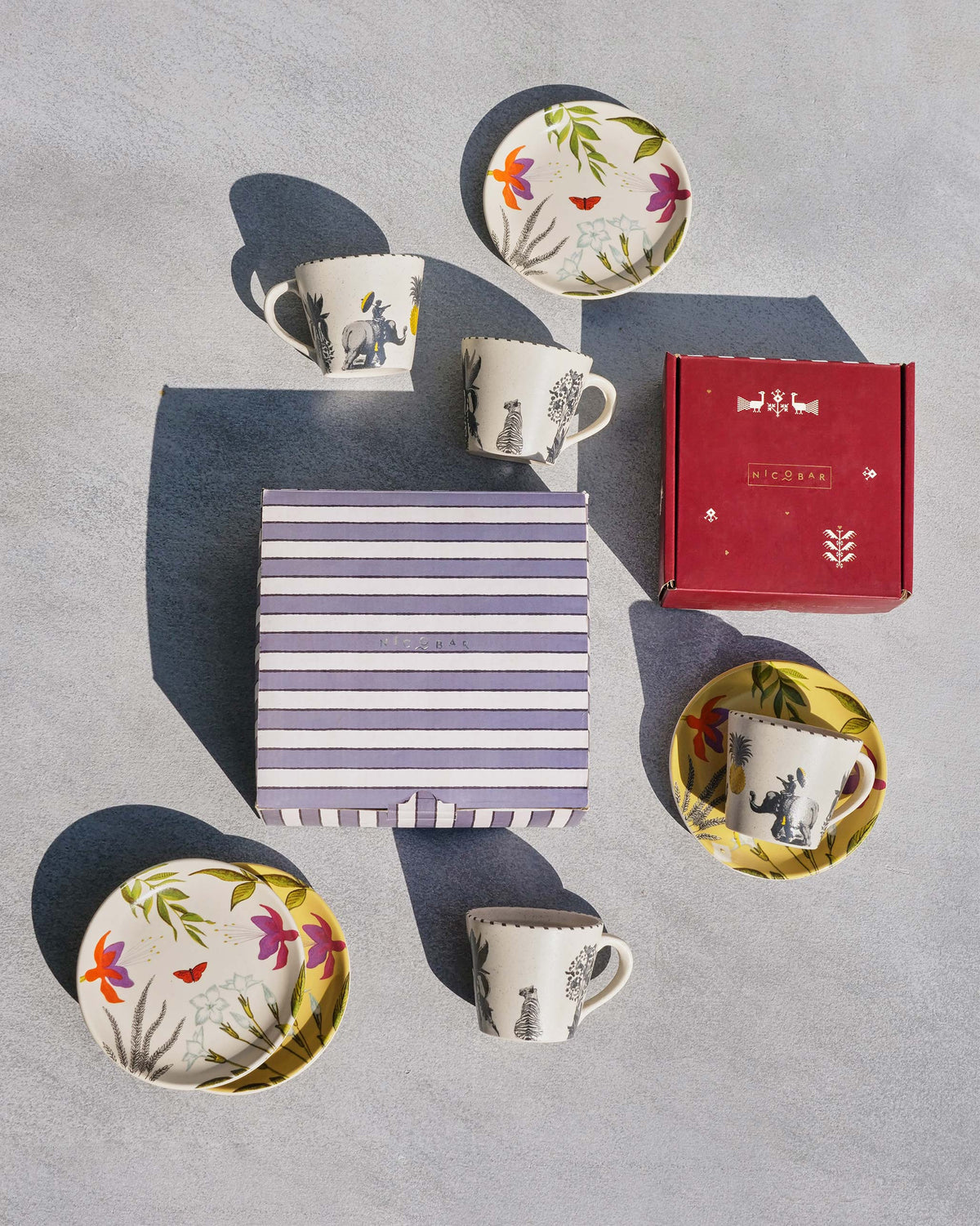 Botanical Brew Set with mugs, floral plates and Nicobar gift boxes.