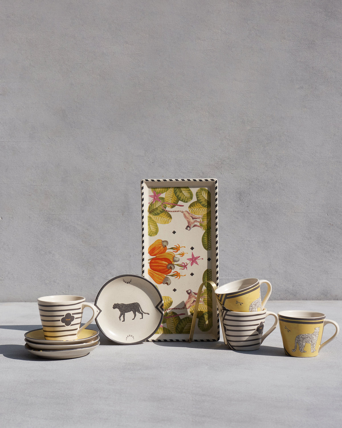 Chand Coffee Set with leopard mugs, cheetah plates, and a cashew cookie tray.