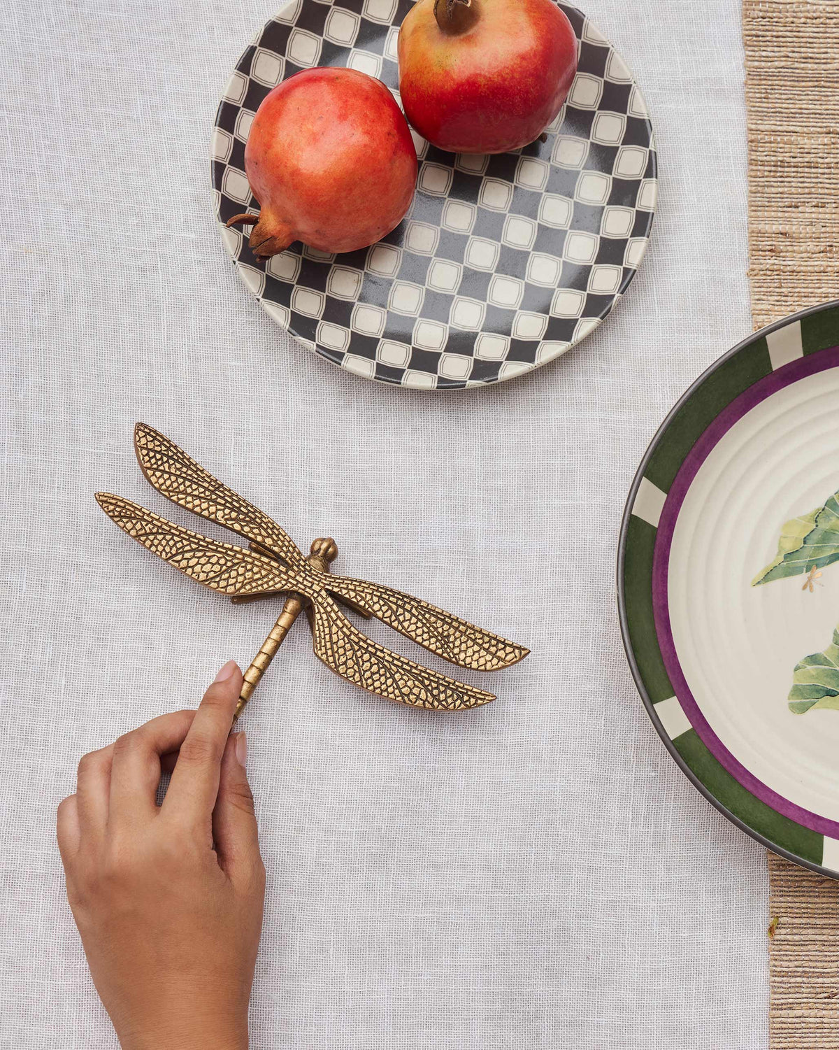 The gold Dragonfly Accent Piece on a set table.