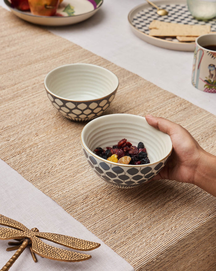 Pair of Fez nut bowls with gold rims, one filled with dried fruit.