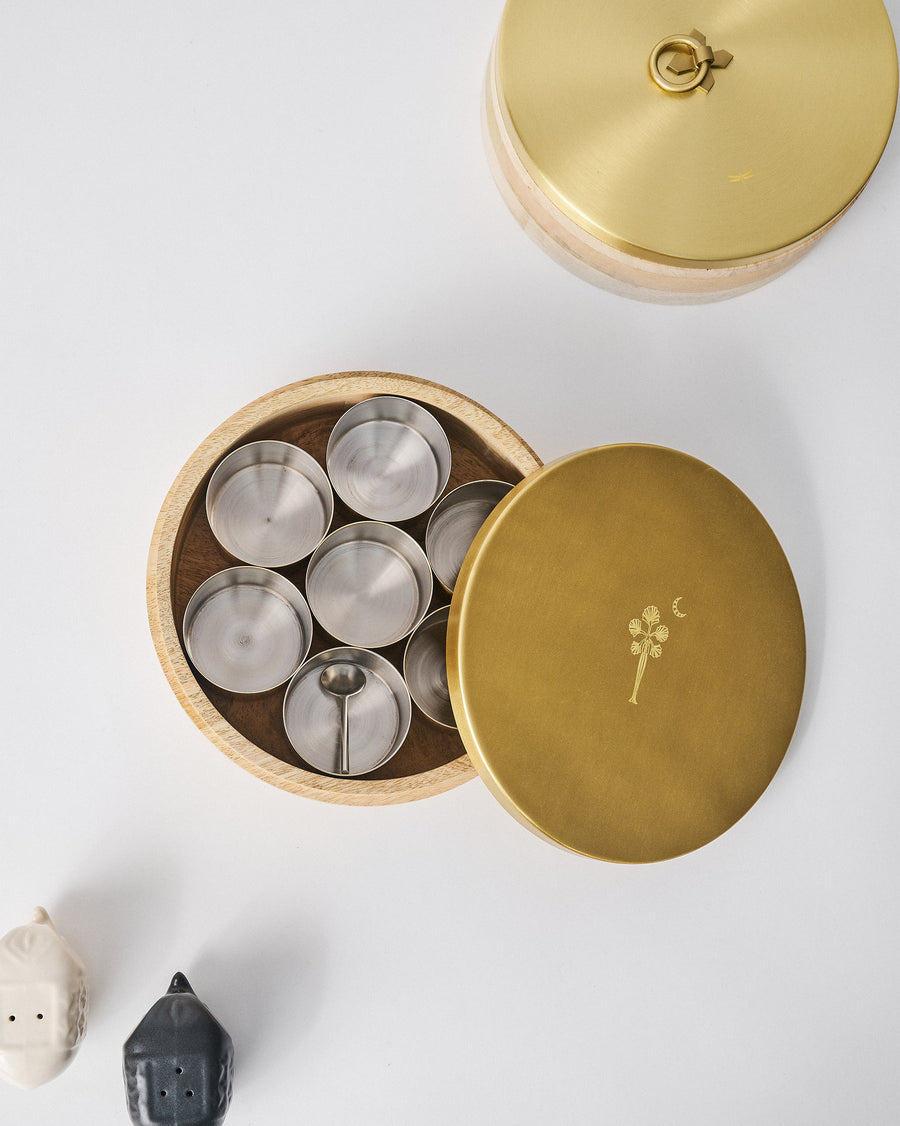 The open Chand Spice Box with its seven containers and spoon.