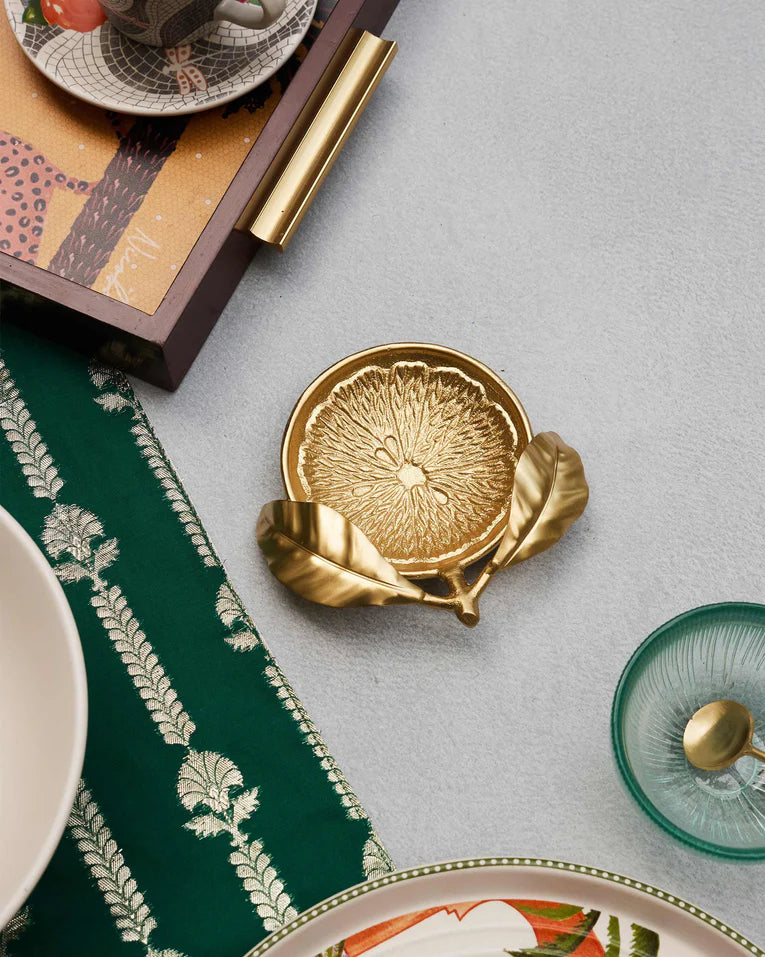 Gold Lemon Trinket Tray styled on a table among homeware.