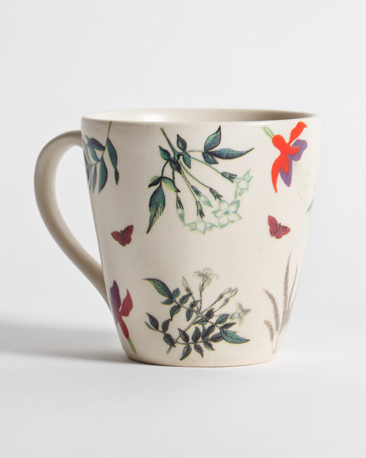 Botanical Mug with flowers and butterflies printed on its cream body.