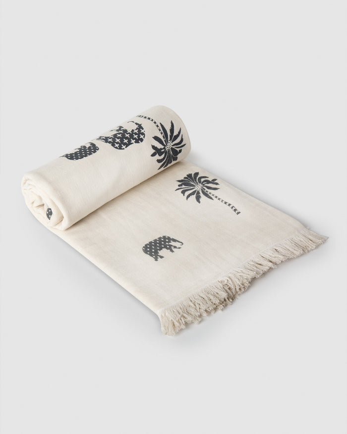 Colombo charcoal throw with palm and elephant print and fringe.