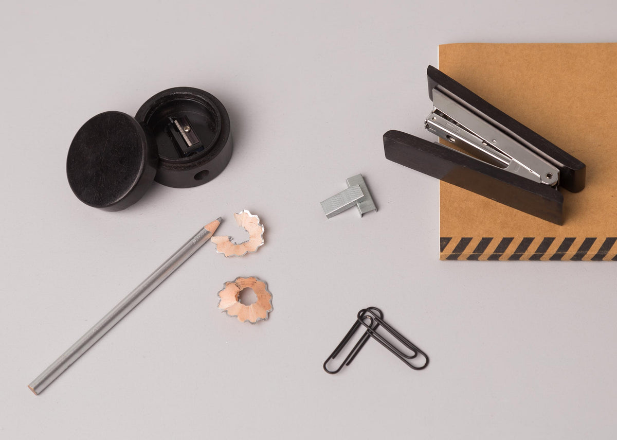 Colombo office set with stapler, sharpener, pencil, and clips on a desk.