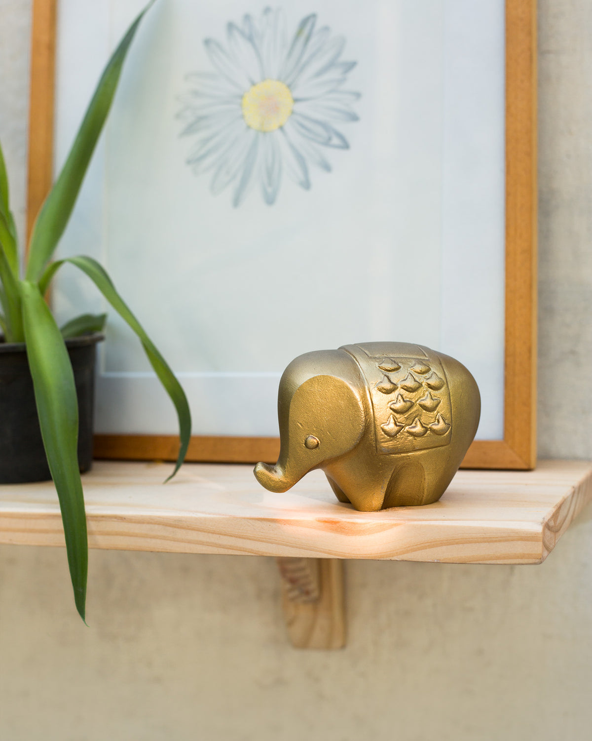 The elephant on a wooden shelf.