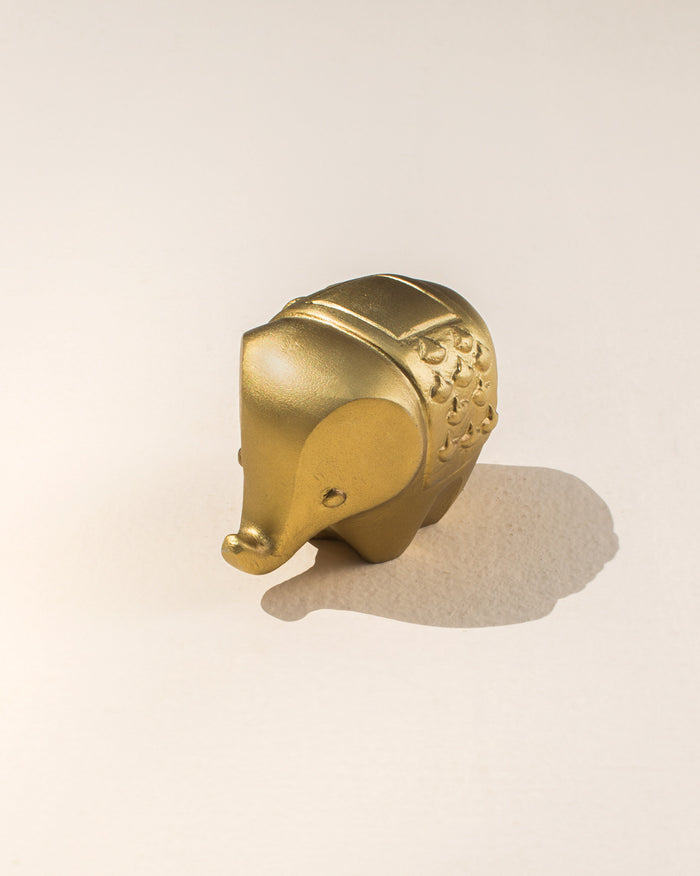 Haathi Decor Accessory in gold, shown as a small elephant with an embossed saddle.