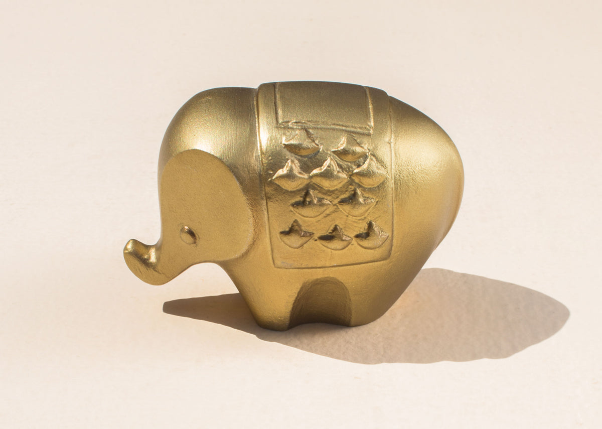 Side view of Haathi Decor Accessory in gold with an embossed saddle.