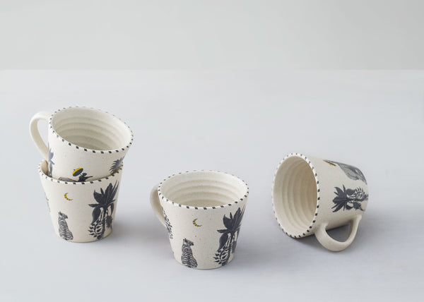 Four mugs grouped, one turned on its side