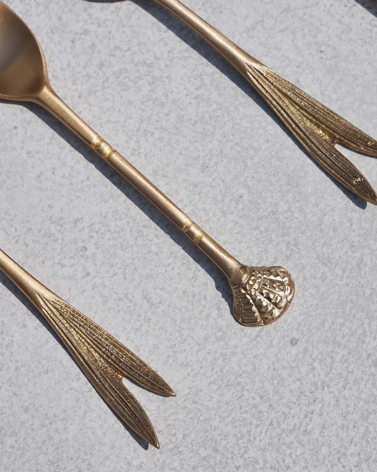 Close-up of Bahr coffee spoon handles showing a shell-shaped end and leaf handle.