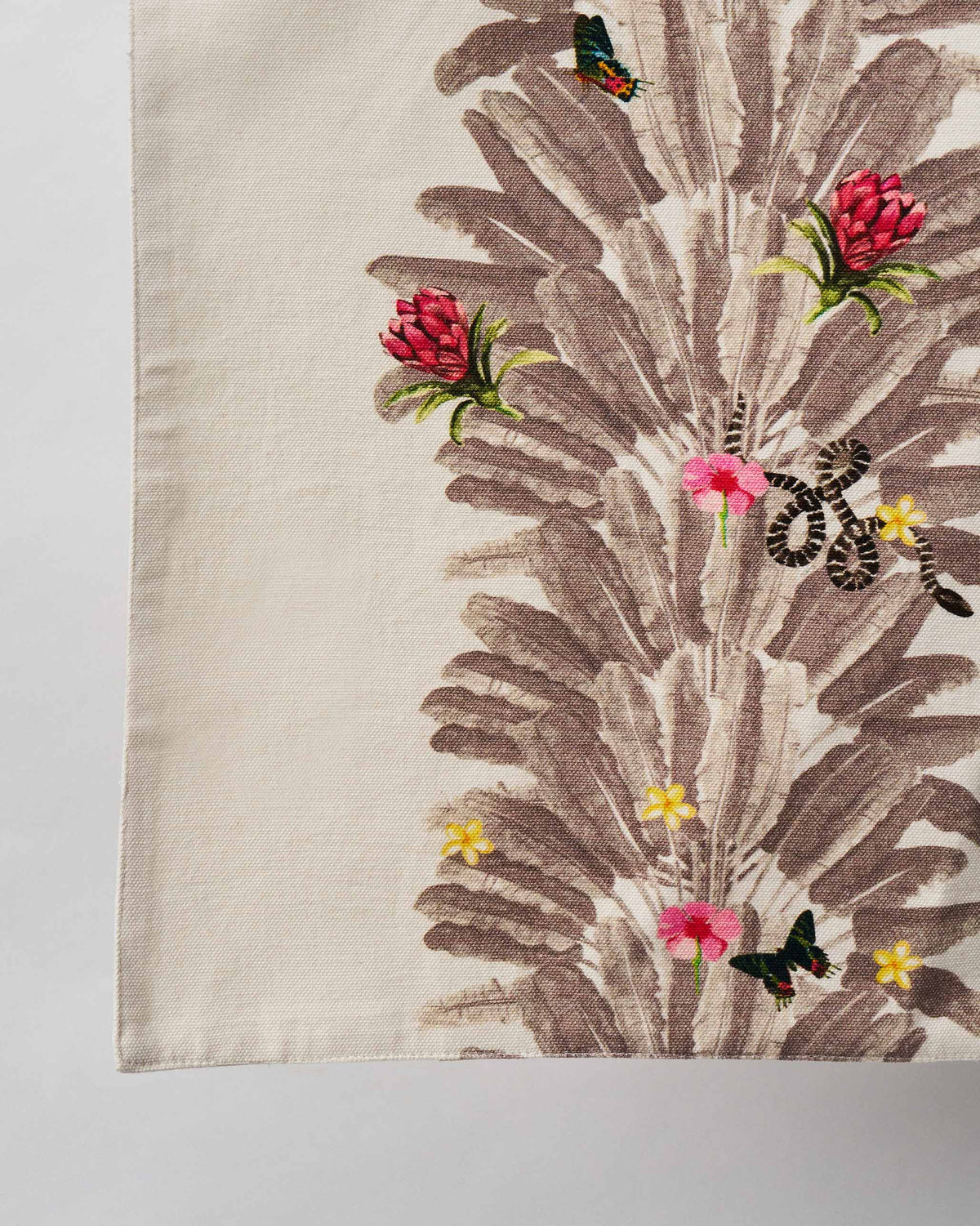 Close-up of Ravenala Runner showing grey palm fronds with pink flowers and butterflies.