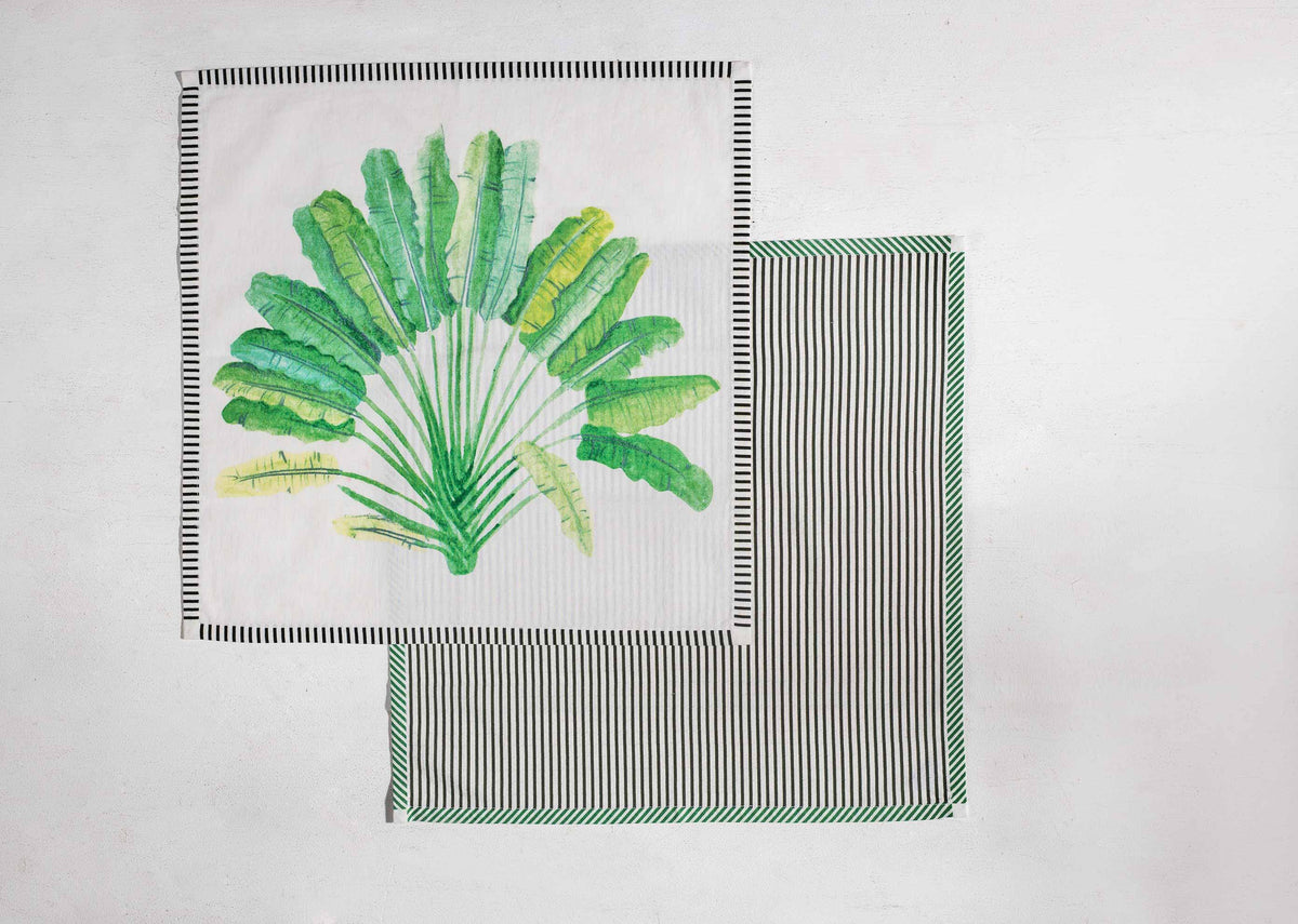 Ravenala napkin with a central traveller palm motif and striped edge.