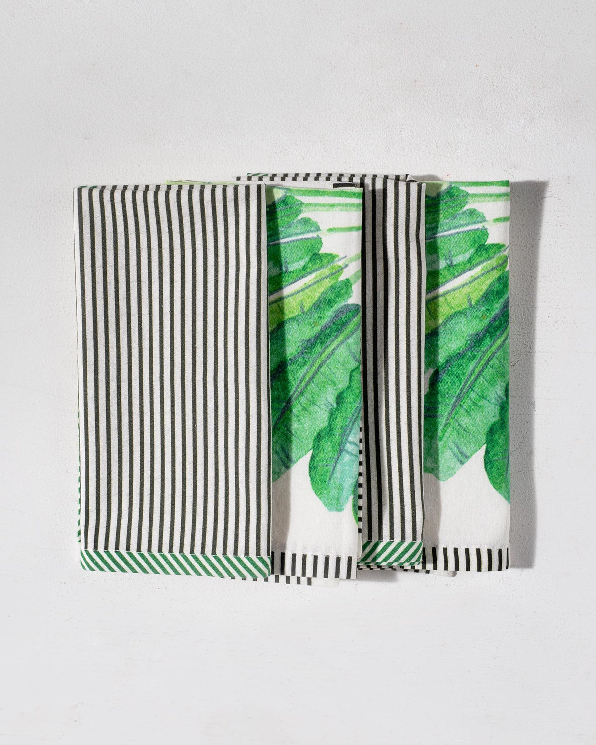 Ravenala napkins showing traveller palm fronts and striped backs.