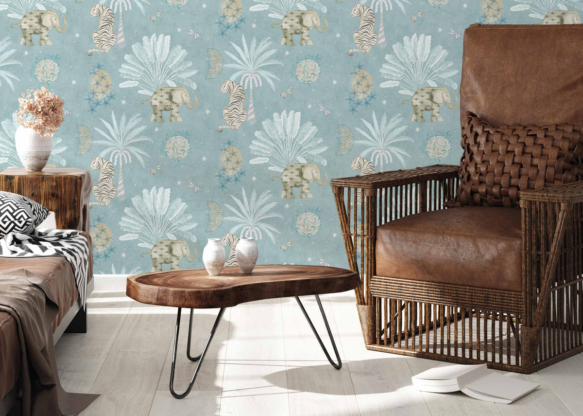 Moonrise Island Wallpaper in blue with tigers and elephants, shown with a leather armchair.