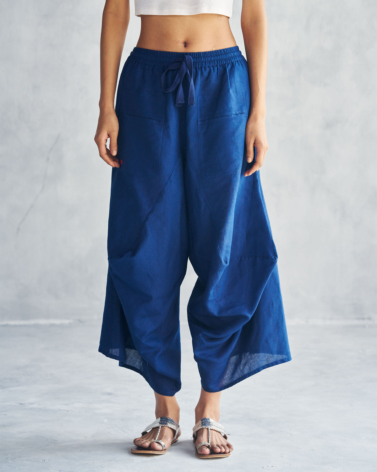 Navy Yoka Trousers with a flared silhouette.