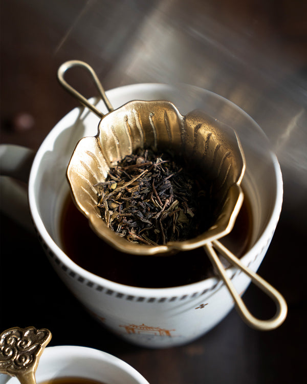 The strainer resting on a cup