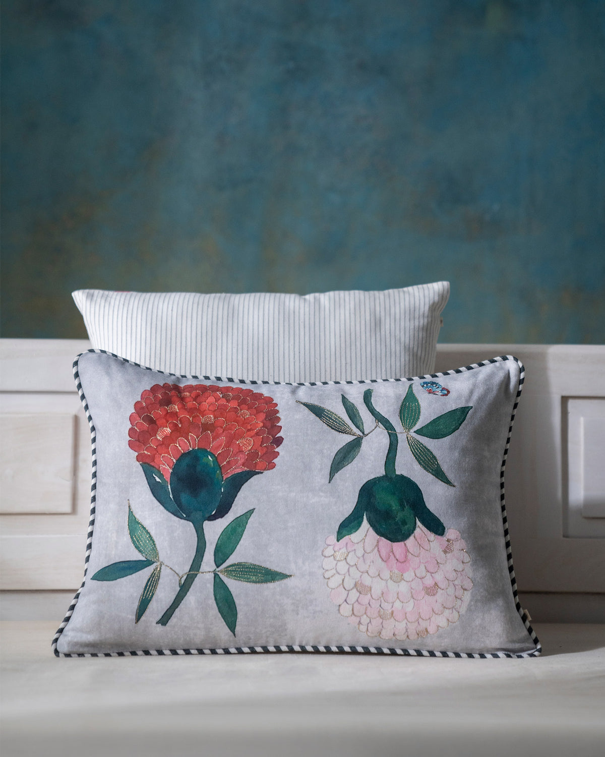 The Peony Cushion Cover in grey with red and pink peony motifs.