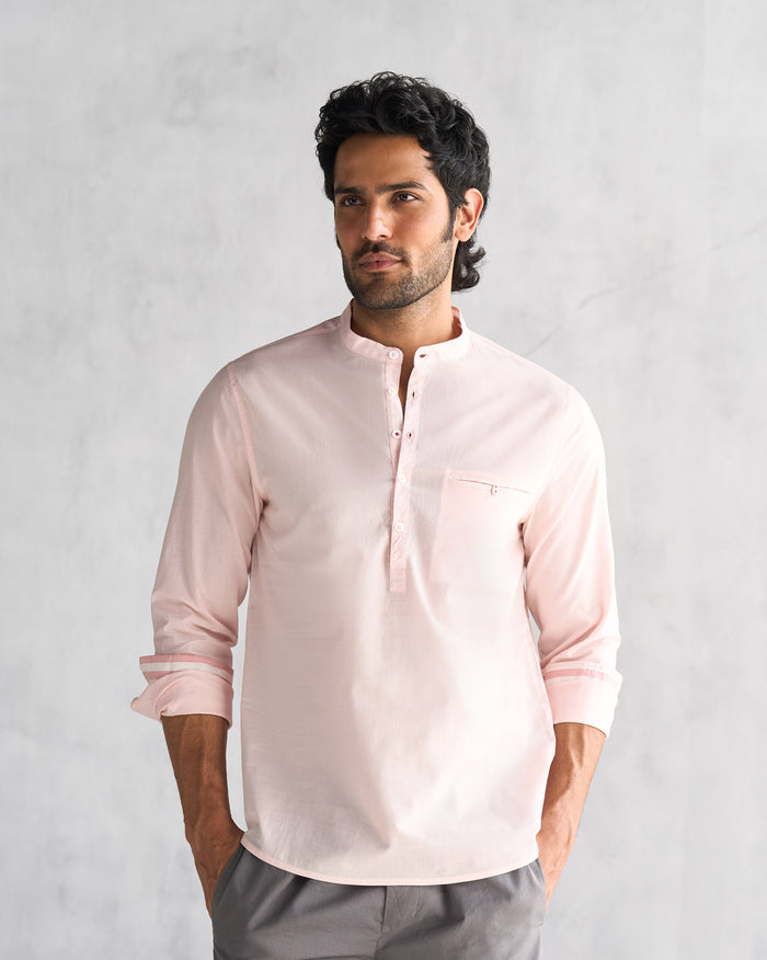 Person wearing a pink Pondicherry shirt with a band collar.