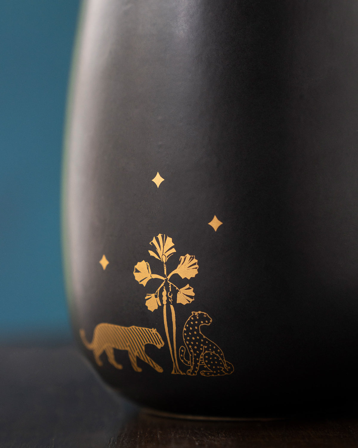 Close-up of gold tiger and leopard motif on the Sher diffuser.