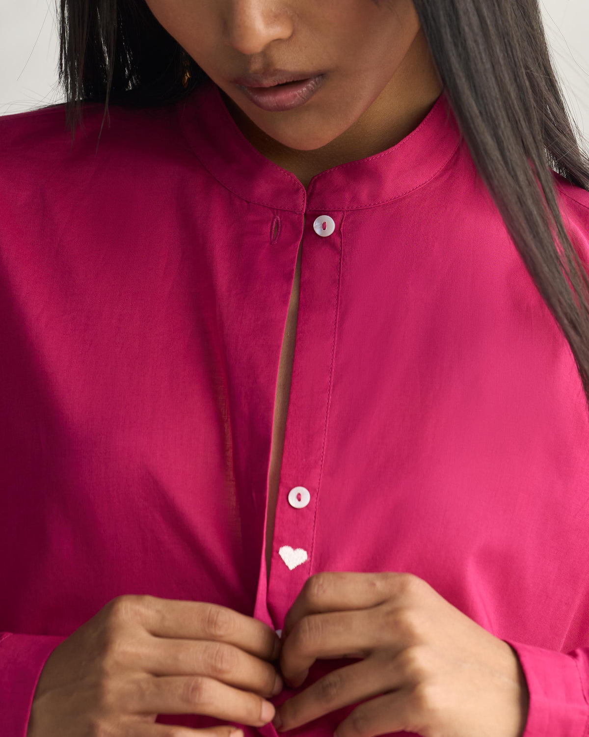 Close-up of a berry long kurta showing the mandarin collar and heart button.