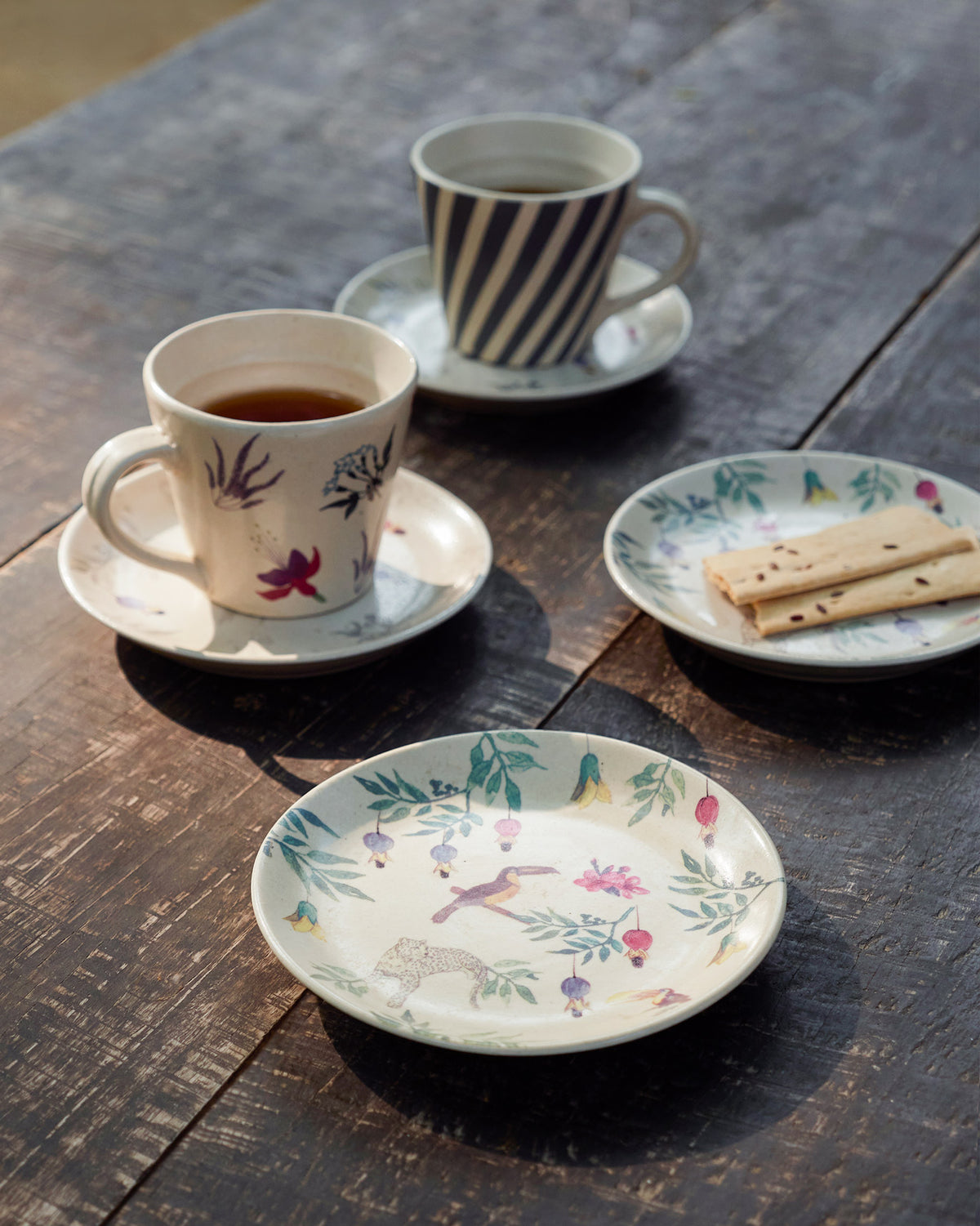 Nakano tapas plate with toucan and leopard print in a tea table setting.