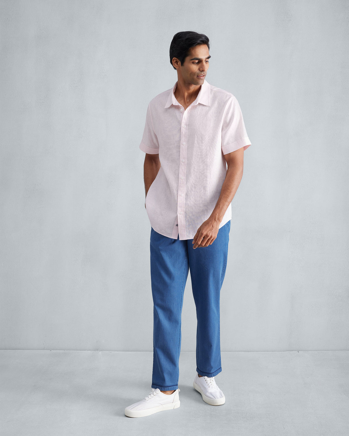 Full-length view of a pink half sleeve shirt worn by a person.