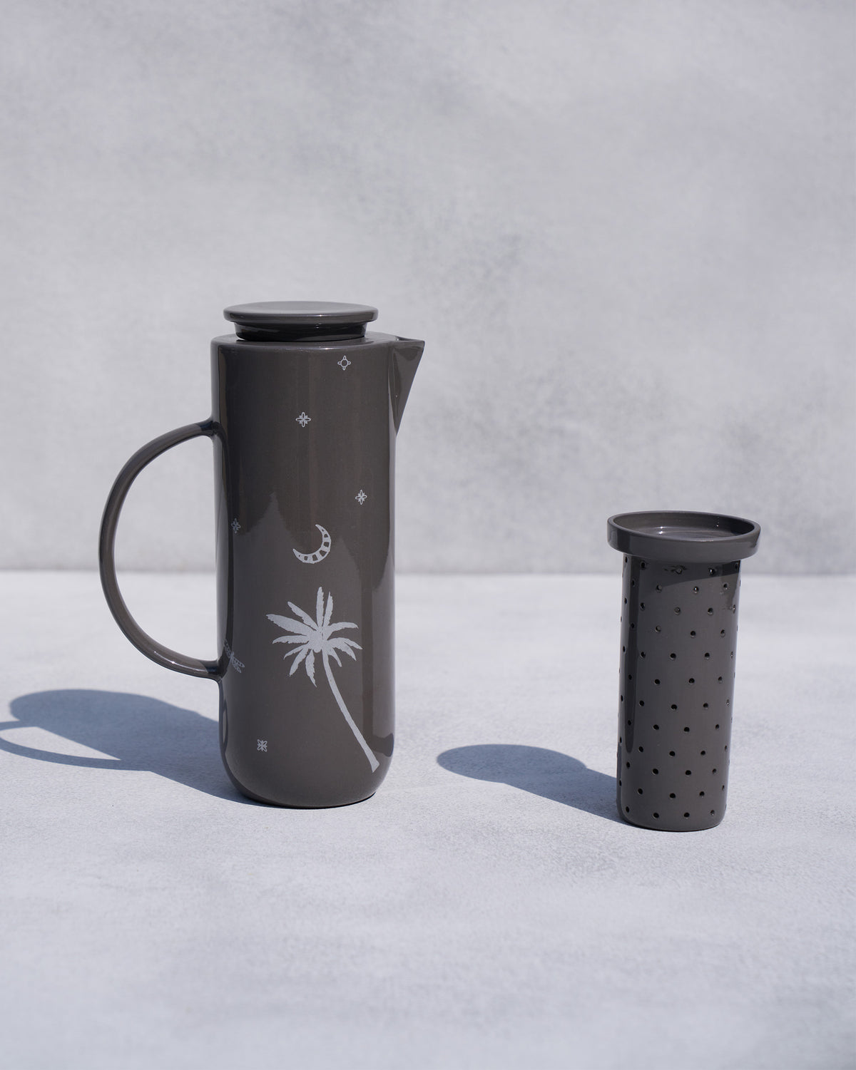 Taramandal Carafe with its separate perforated infuser beside it.