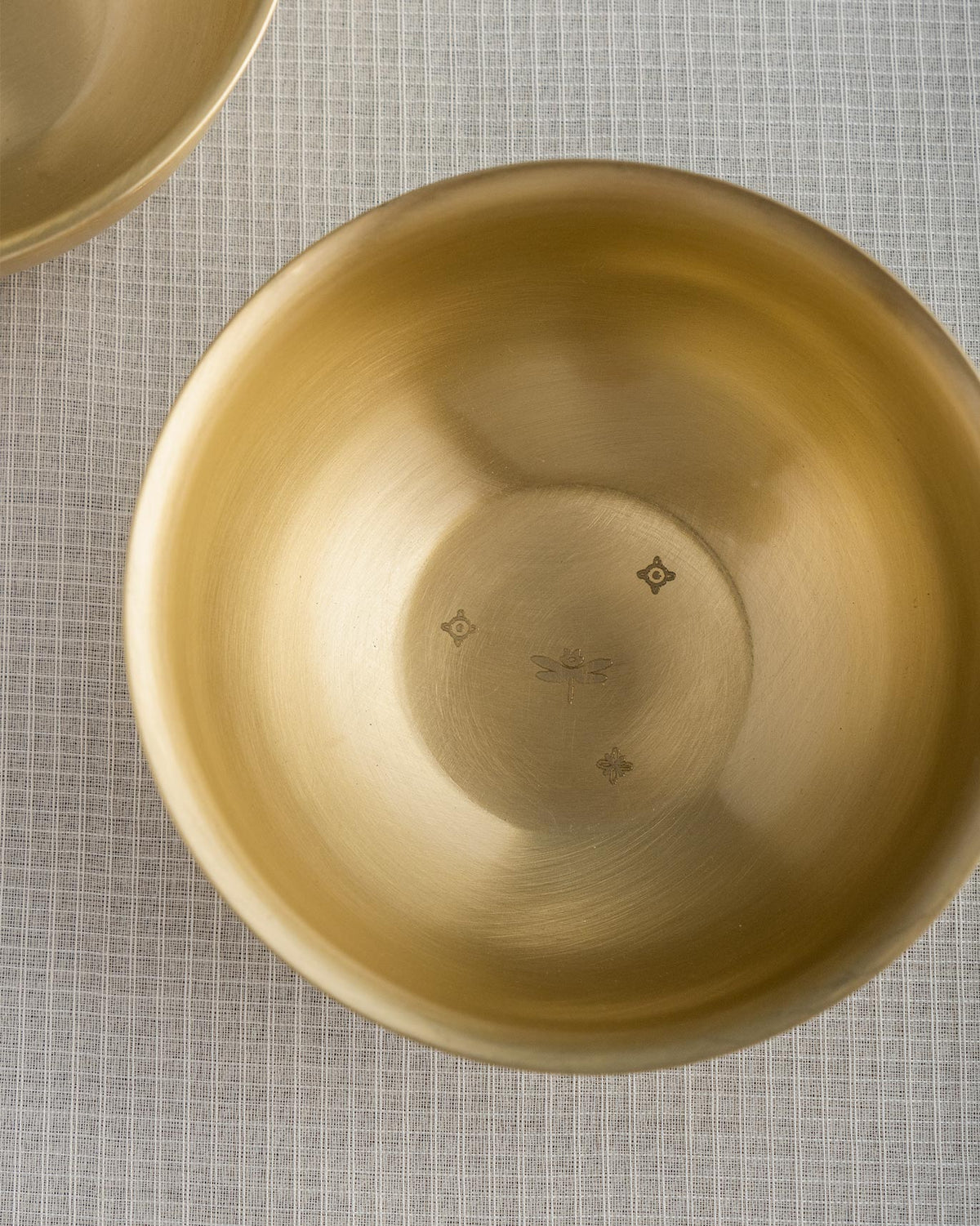 Close-up of Madhu dessert bowl showing a dragonfly etched in the base.