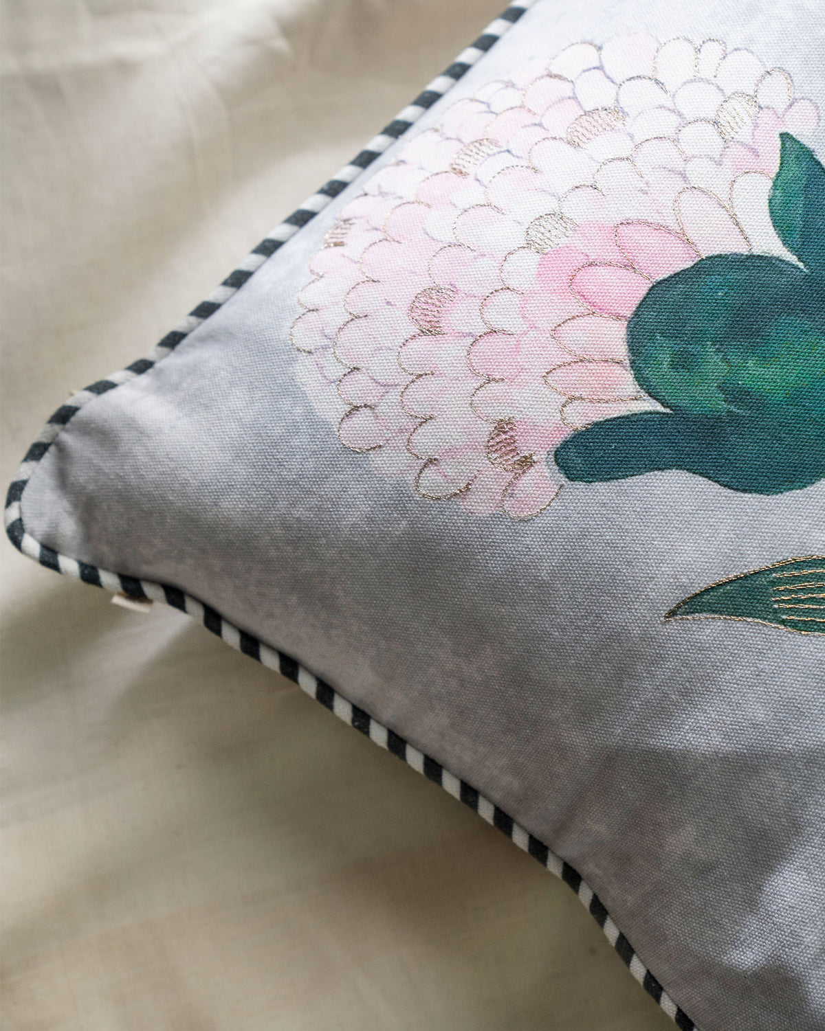 Close-up of the Peony Cushion Cover showing a pink peony bloom and green leaves.