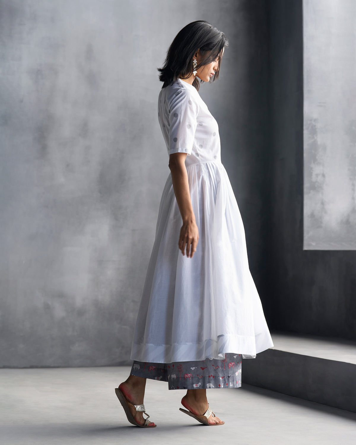 Side view of a white front-overlap yoke kurta with a flared skirt.