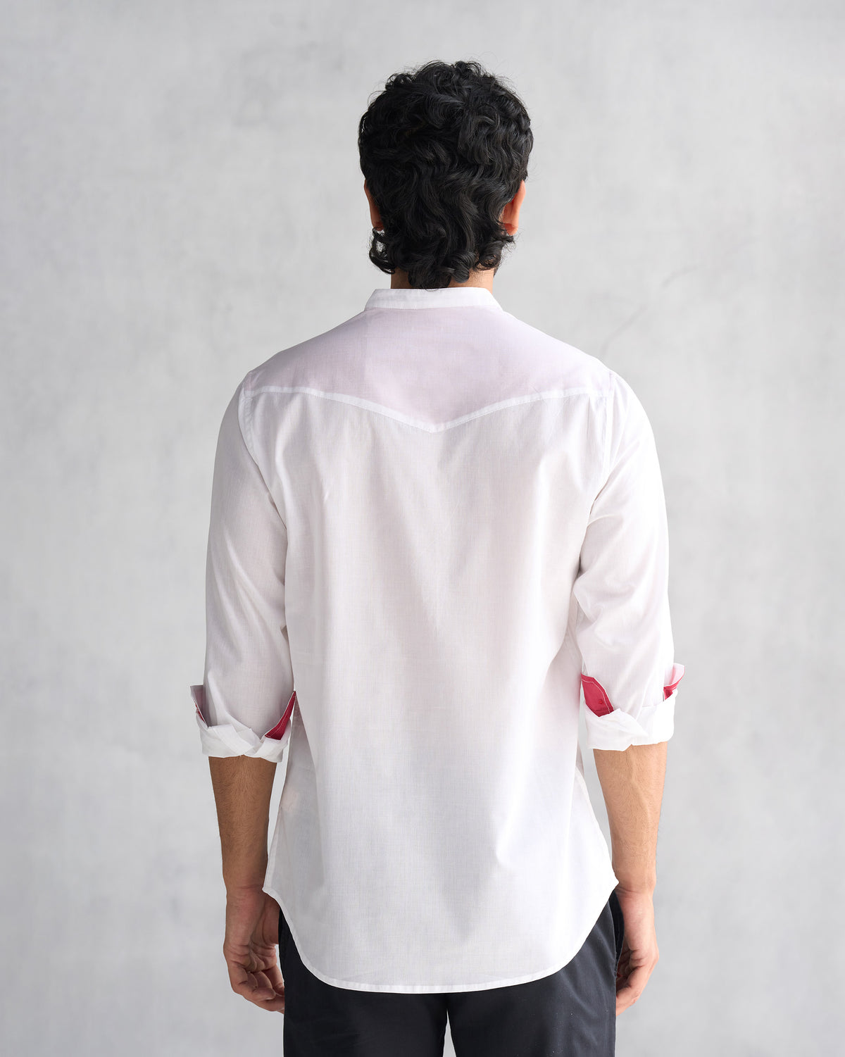 Back of a white Pondicherry shirt worn by a person.