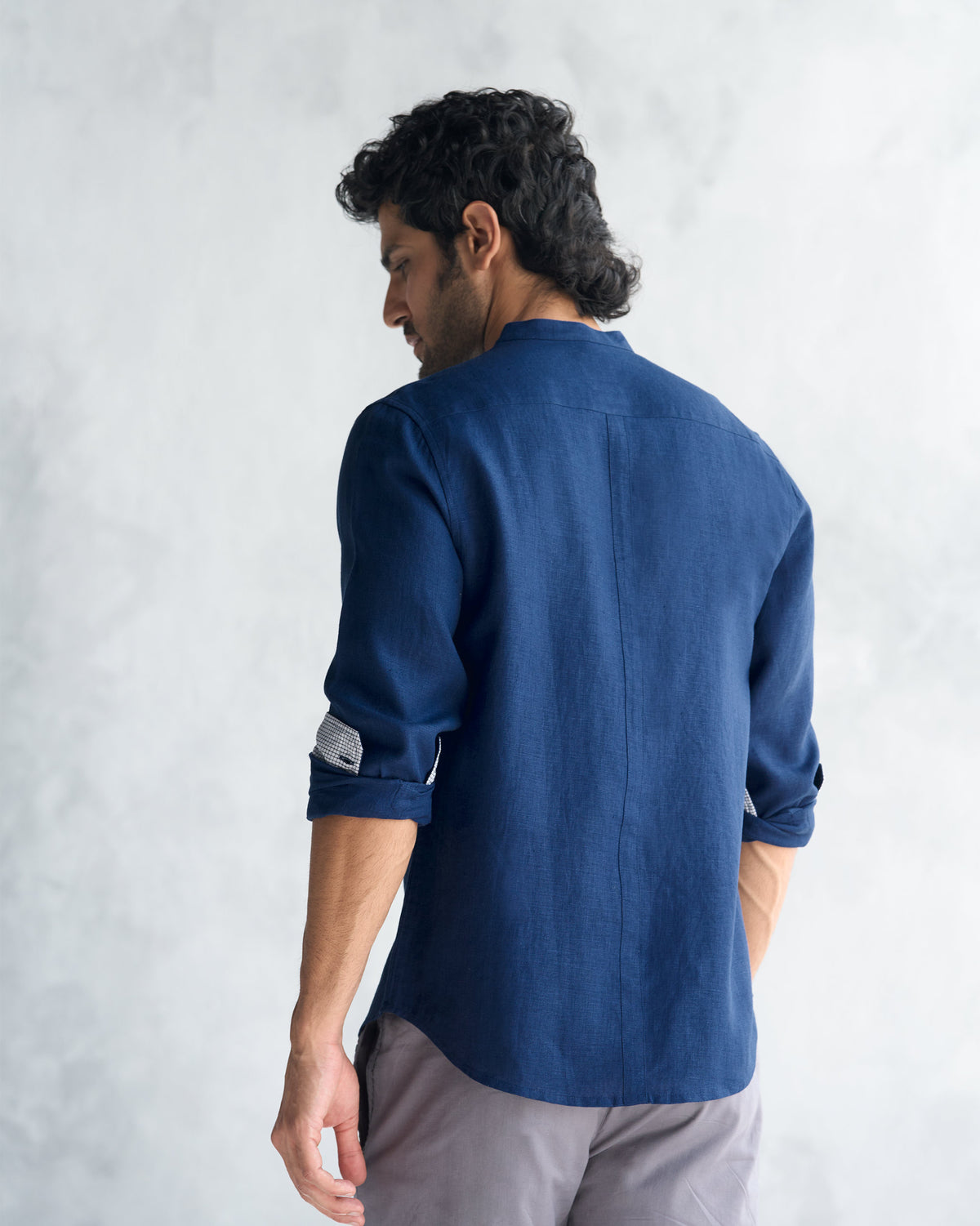 Back of a navy Nawab shirt worn by a person.