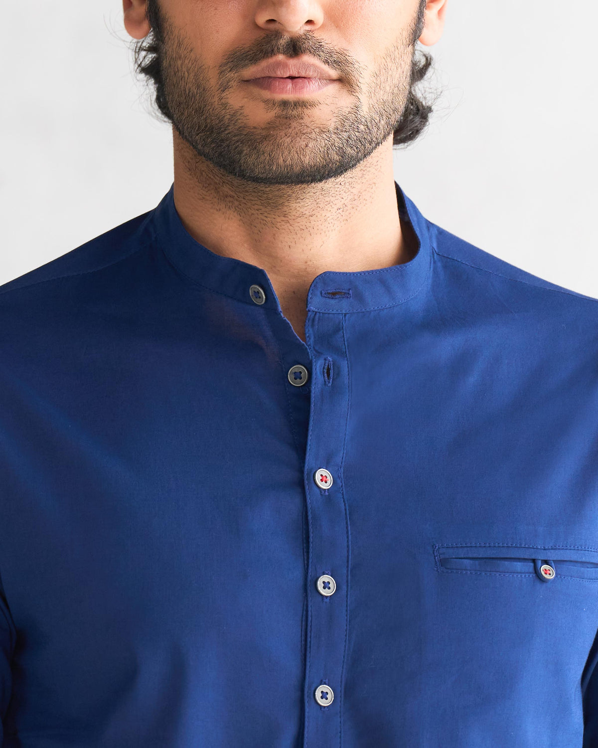 Close-up of a blue Pondicherry shirt showing mandarin collar and chest pocket.