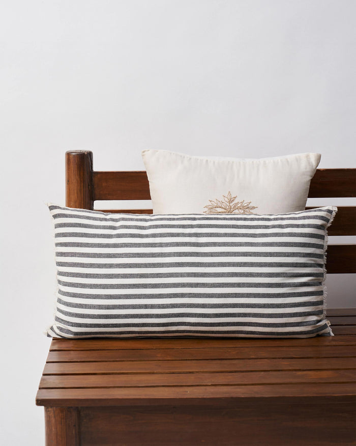 Close-up of Black & White pillow cover showing a piped edge and black stripes.