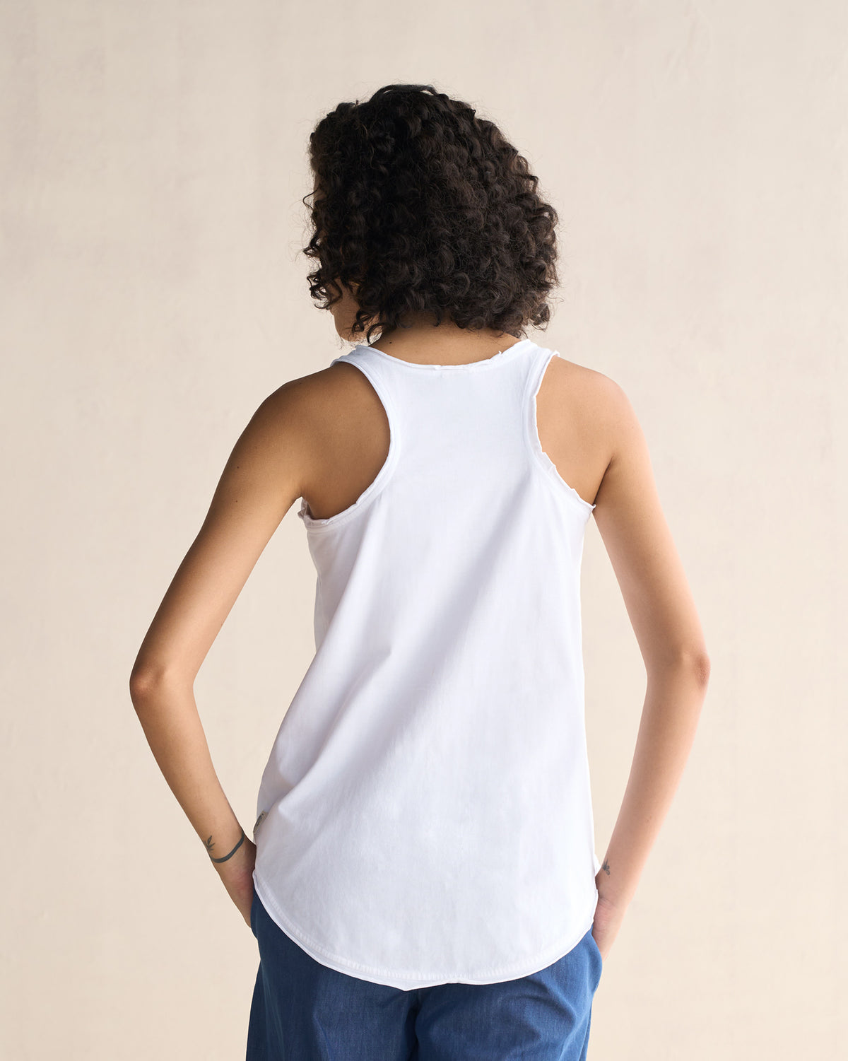 Back of a white Ukiyo racerback tank showing the racerback straps.