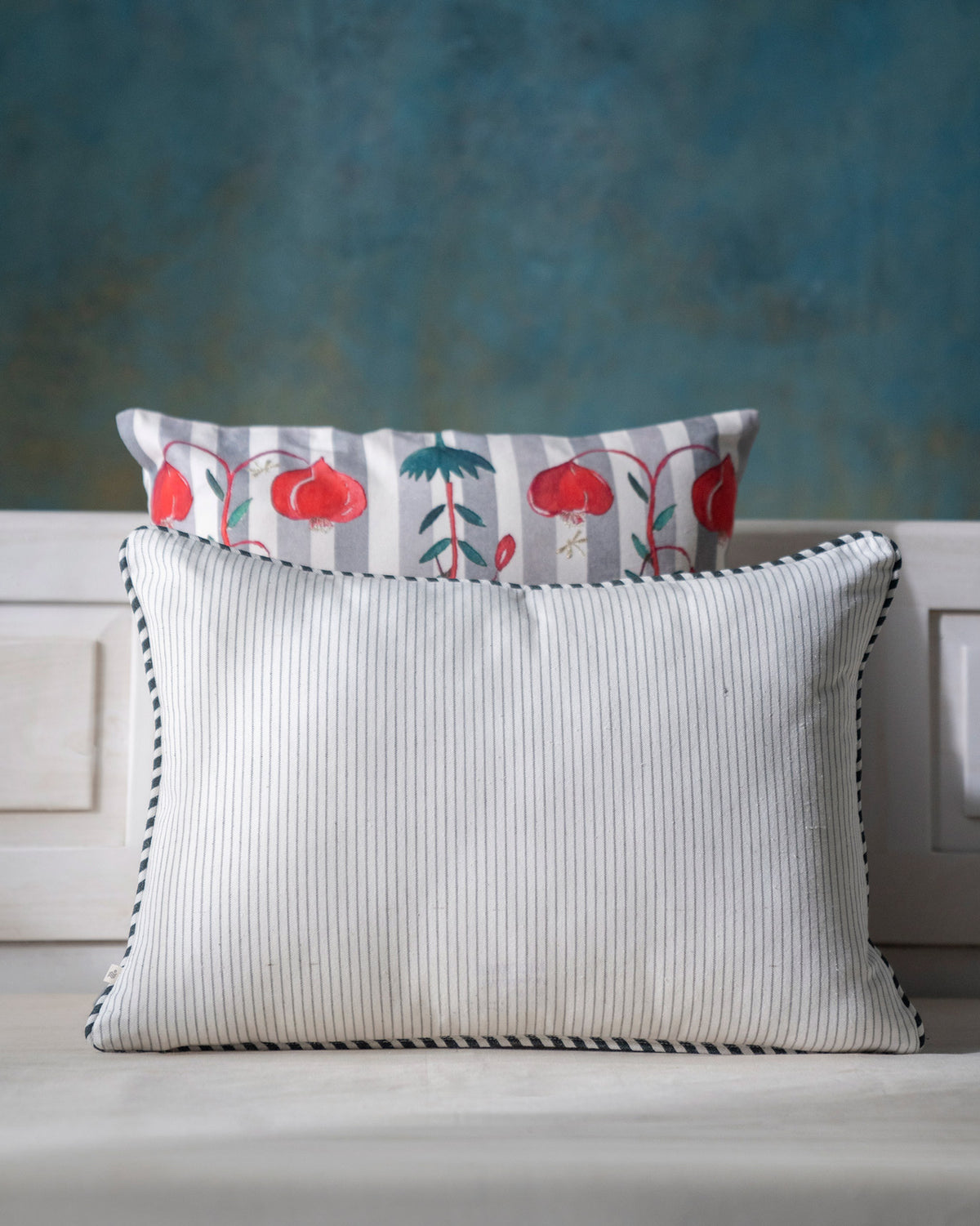 Back of the Peony Cushion Cover in cream pinstriped fabric.