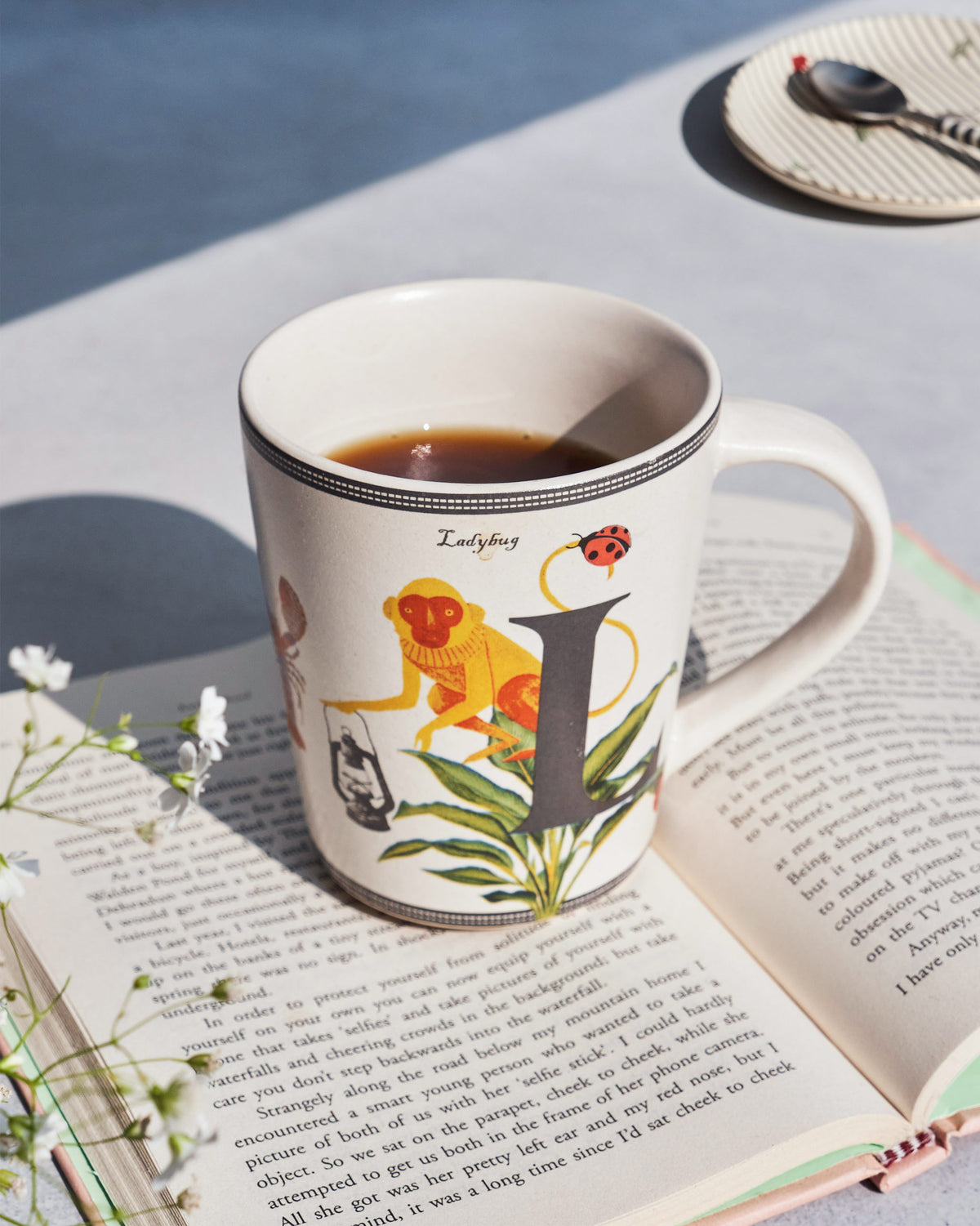 The Langoor Mug resting on an open book.