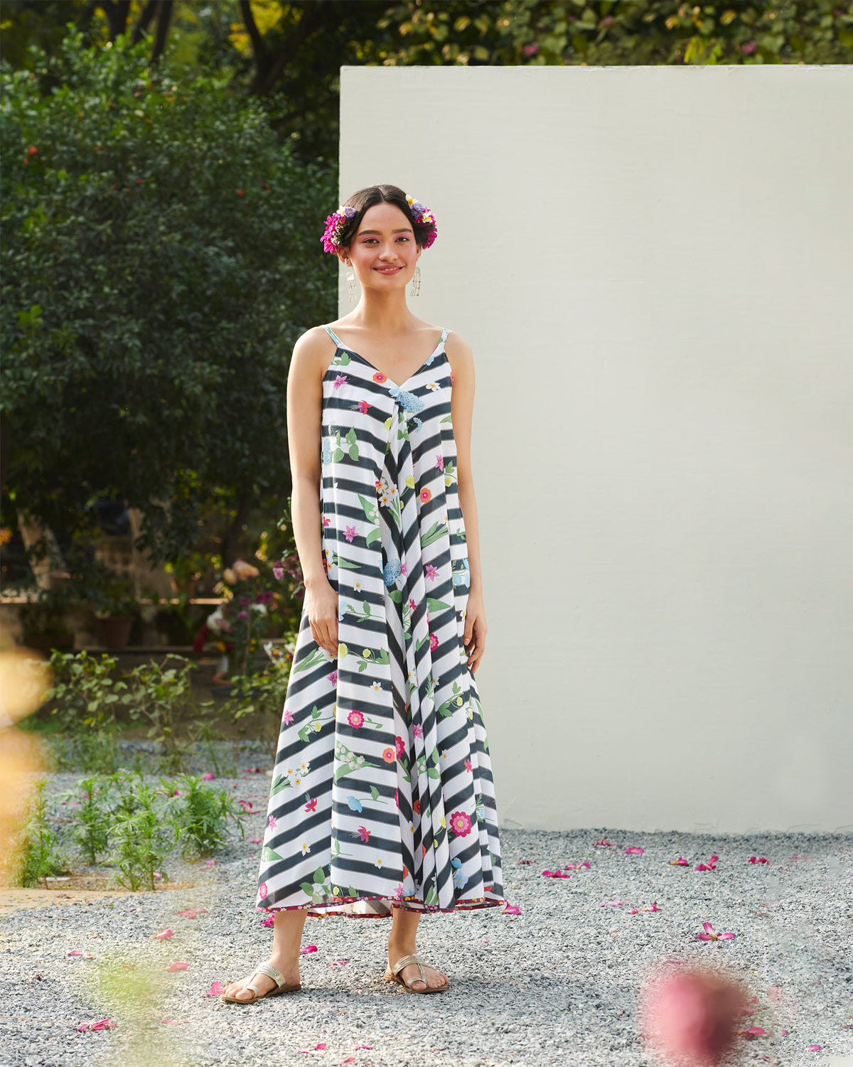Person wearing a black and white striped V-neck dress with floral print.