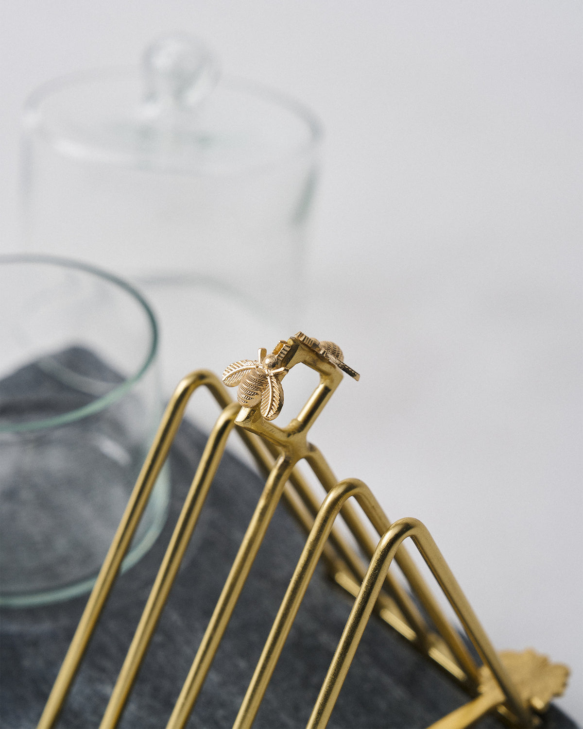 Close-up of the gold bee on a Mahi breakfast tray toast rack.