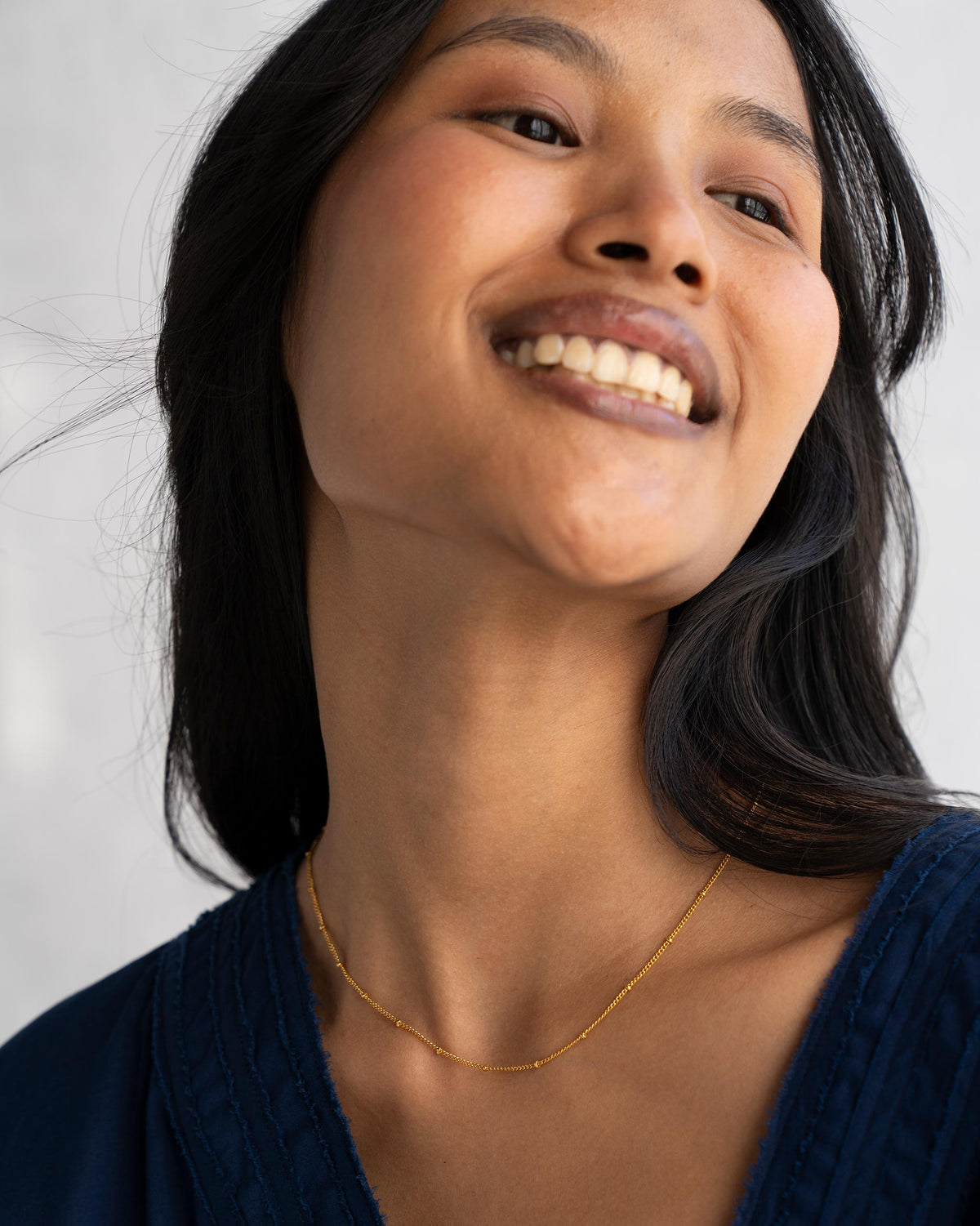 Person wearing extra small Boondi Chain in gold.