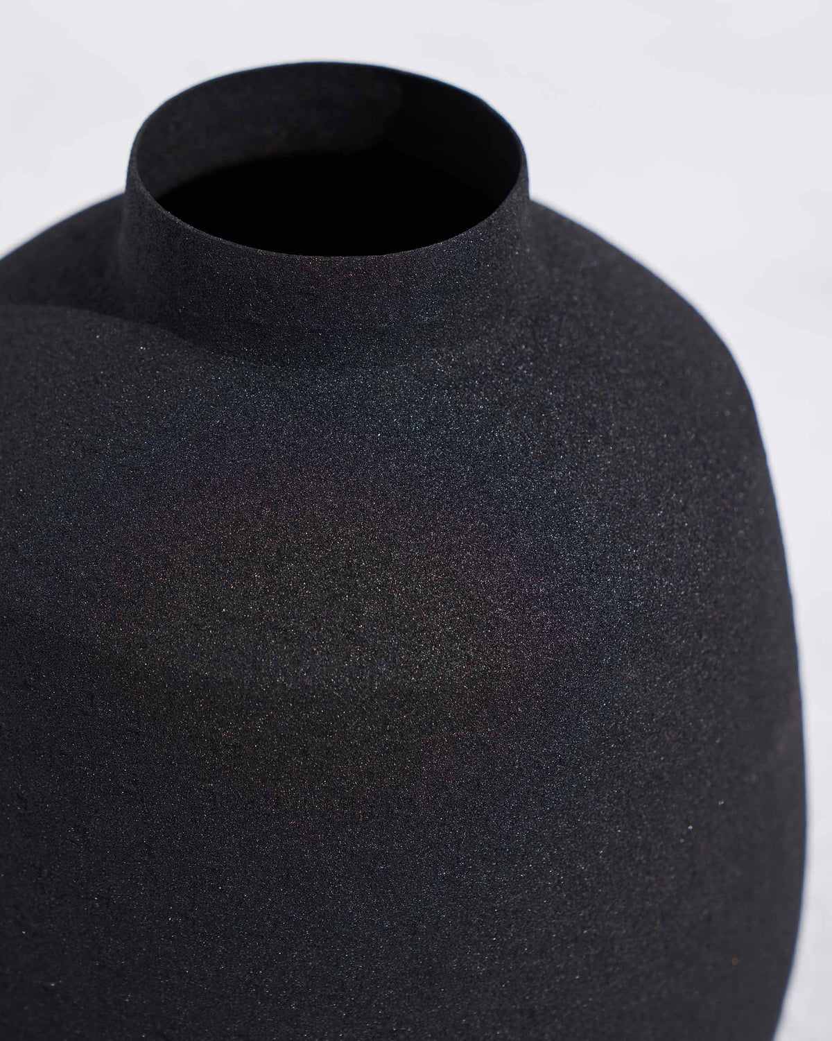 Close-up of the Dhaara vase neck showing its matte black texture.